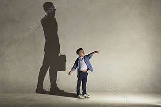 The little boy dreaming about businessman profession