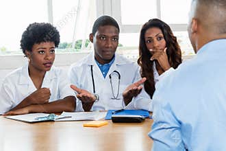 Group of african american doctors with patient