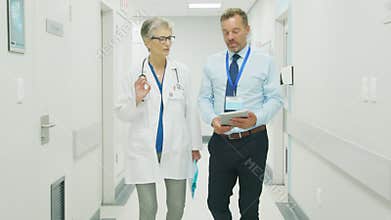 Doctor and pharmaceutical agent discussing