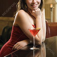 Woman at bar with drink.