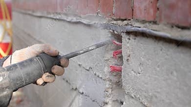 Construction work. Puncher making holes in concrete.