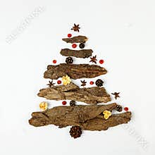 Zero Waste Christmas concept. Eco-friendly christmas tree made of natural tree bark with star anise, rowan and bumps. New year or