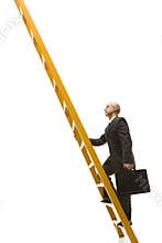Businessman climbing ladder.