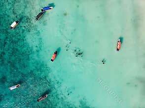 NUNGWI, ZANZIBAR - JANUARY 2020: Aerial Drone Shot of Wooden Traditional Dhow Boats and Black local African Kids