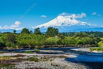 The beautiful nature of Patagonia forests the volcano of the river and lake through the sunset