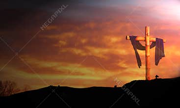 Wooden cross under sunrise