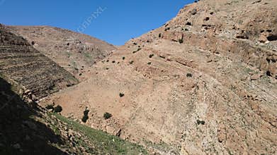 Aerial drone shot of dry valley and mountains at Binyamin Region in Blue sky, Judea and Samaria Area, Israel