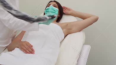 Laser hair armpits removal procedure. Cosmetology. Beauty clinic.