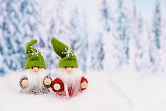 Little cute christmas elves standing in the snow, forest, festive greeting card, copy space