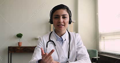 Young indian general practitioner holding video call.