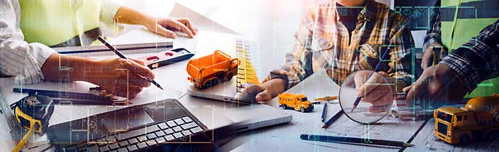 Engineers or architects is watching on model building and blueprint in working site.Construction and structure concept