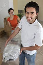 Couple carrying carpet