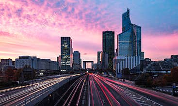 Cars trails and moves in to and out from La Defense, business district night, Paris