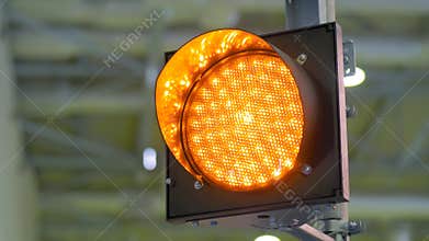 Signal LED orange traffic light blinking at transport exhibition - close up