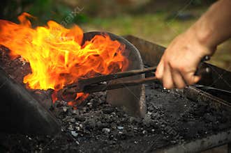 Blacksmith heating up iron