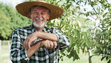 Handheld video portrait of happy farmer in a straw hat.