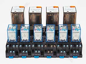 Different electromagnetic industrial relays on white