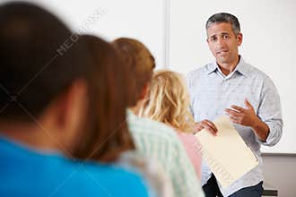 Tutor teaching class of students