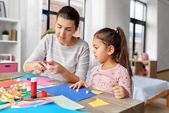 daughter with mother making applique at home