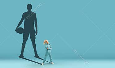 Conceptual image with boy and shadow of fit male basketball player on blue background. Childhood and dream about big and