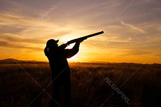 Hunter Shooting in Sunset