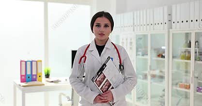 Doctor woman radiologist in lab coat with ultrasound results