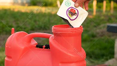 pour herbicide into the sprayer. Selective focus.