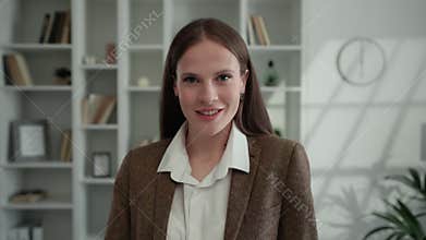 Portrait of the Charming Female Teacher Sits on the Background of Apartments. Home Office