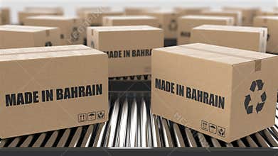 Cardboard boxes with Made in Bahrain text on roller conveyor