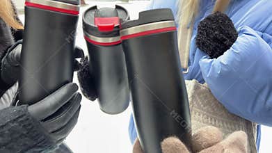 Girlfriend's bachelorette party met three identical thermoses in hands with gloves from tsokovets girls with a