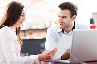 Business people using laptop at cafe