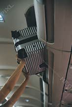 Cabin crew lift luggage bag in airplane . Airline transportation and tourism concept