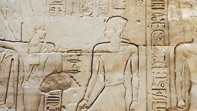 Ancient Egyptian hieroglyphs and bas-reliefs close-up in Luxor Temple, ancient Thebes, Egypt. Luxor Temple is a large