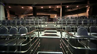 Stairs among rows of seats in empty illuminated