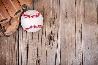 Baseball and mitt on wooden background