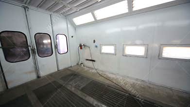 Inside empty paint-spraying booth with metal walls
