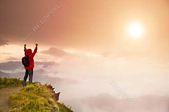 Young man standing on top of mountain