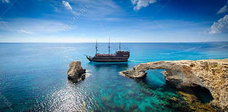 Pirate ship by rock arch,cyprus