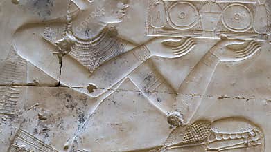Ancient Egyptian hieroglyphs and bas-reliefs close-up in Temple of Seti I in Abydos, Egypt. Temple of Seti I