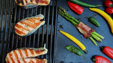Salmon steak with vegetables on the cast iron grill barbecue. Seafood. Salmon grilled.