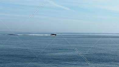 A motorboat is sailing at high speed in the sea near Monaco