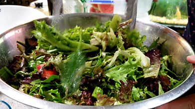 Tossing freshly prepared vegetable salad