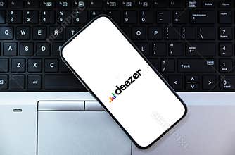 Deezer on the mobile screen with white isolated background, music streaming company editorial backdrop