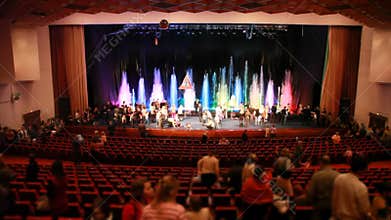 Adults and children after show rises up from red