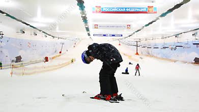 little skier boy holds balance and does some