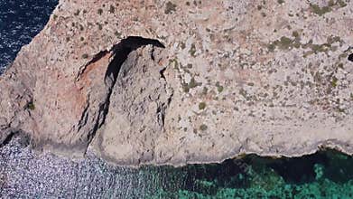 Natural windows in the rocks, Comino Island Malta, Close up revealing drone shot