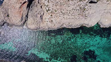 Natural windows in the rocks, Comino Island Malta, Close up revealing drone shot