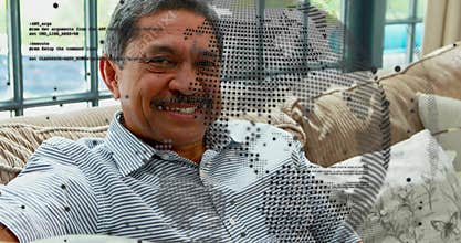 Smiling senior man leaning into sofa cushions in living room, with halftone overlay, striped polo