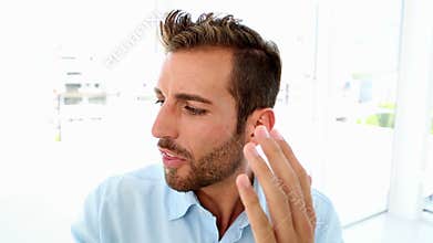 Angry businessman yelling down the phone