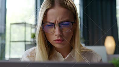 Puzzled Caucasian business woman in eyeglasses trying see blurry monitor service website take off glasses looking in